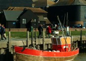 An old wooden fishing boat moored at the quayside