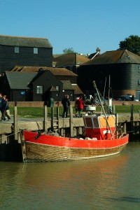 An old wooden fishing boat moored at the quayside